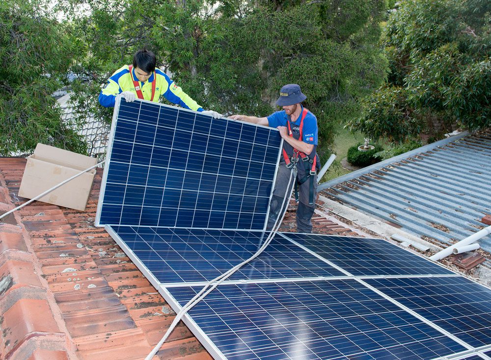 Sharpe Energy Hub two male Technicians installing Solar Panel on roof